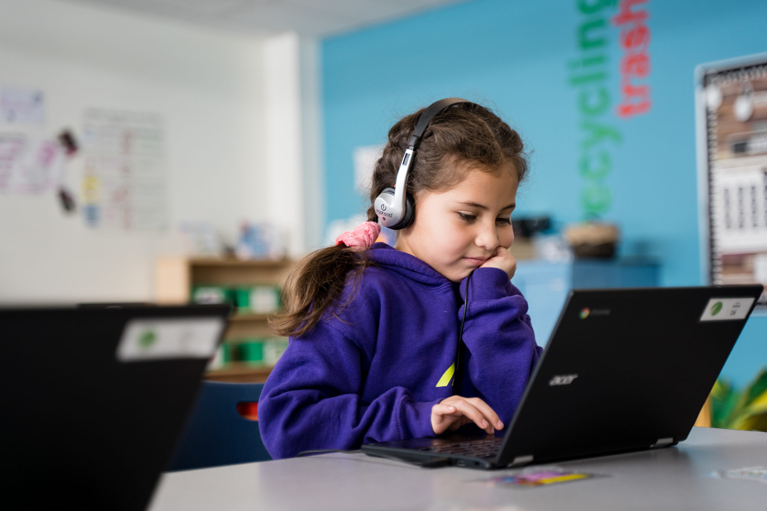 Girl with headphones and computer remote learning