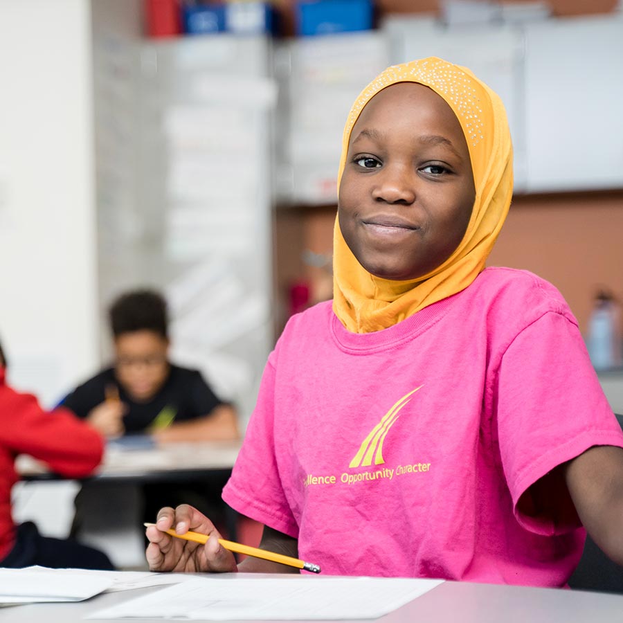 Girl in the classroom wearing SOAR t-shirt