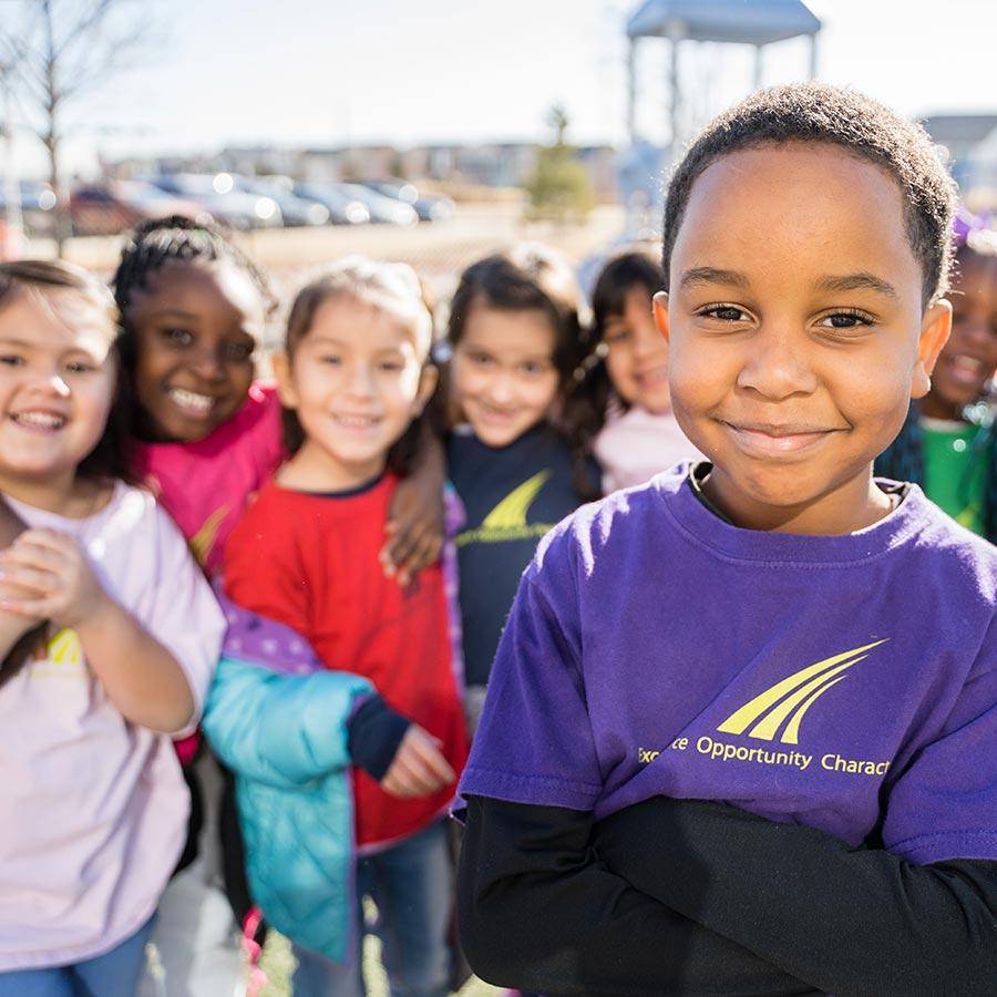 Children smiling while outside on playground